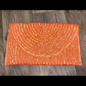 Coral raffia clutch